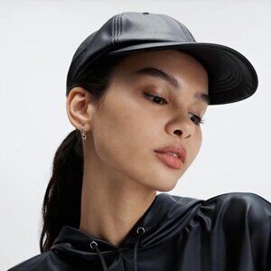 Black faux leather cap with adjustable strap